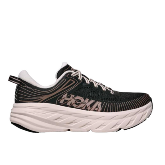 A Hoka running shoe in black and white, featuring a thick white cushioned sole, white laces, and a black mesh upper with a pinkish-brown Hoka logo on the side.