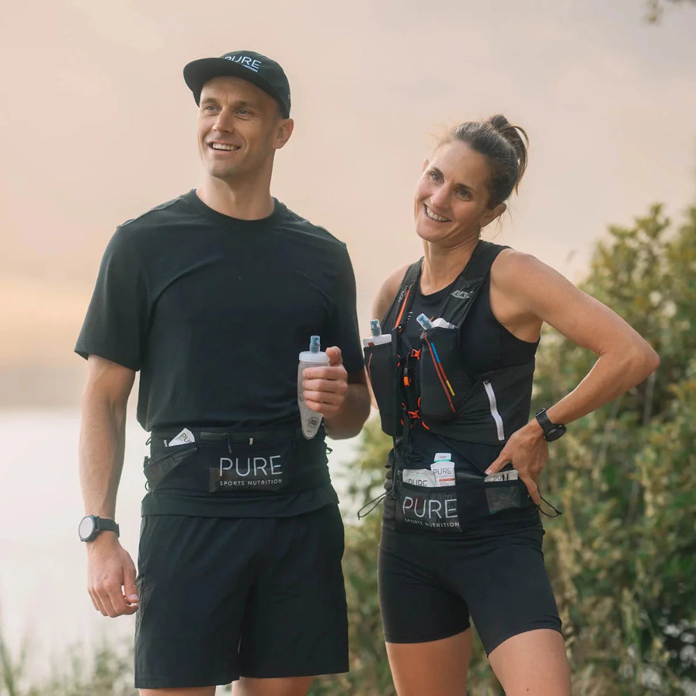 Two runners wearing black athletic gear with 'PURE' branding trail belt