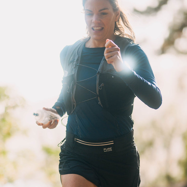 Woman running outdoors with a blurred natural background
