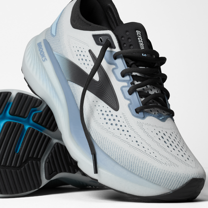 White running shoe with black and blue accents on a white background